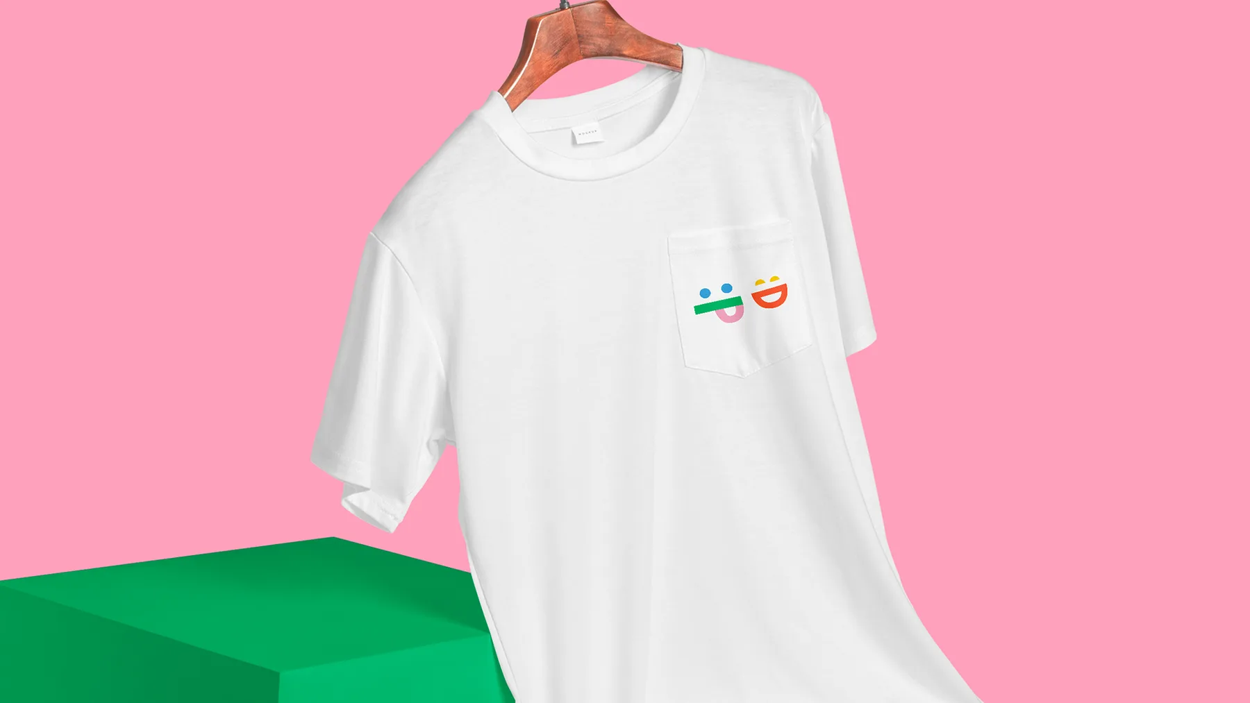 Camiseta blanca con el logotipo bordado, sobre fondo rosa